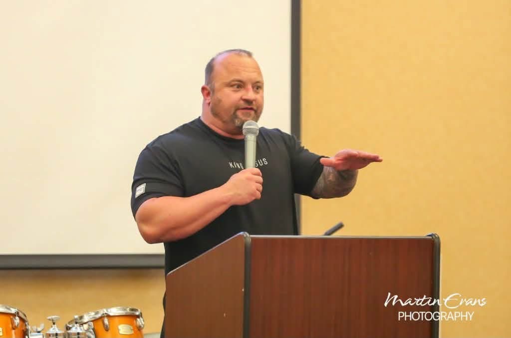 Bart Smith preaching with a microphone at a podium